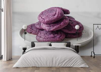 a plate of purple cookies on a white table Wall mural