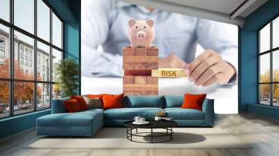 pink ceramic piggy bank with wooden stack toy, insurance risk concept Wall mural