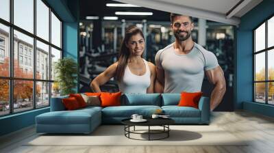 couple flexing their muscles, working out in gym, health and wellness Wall mural