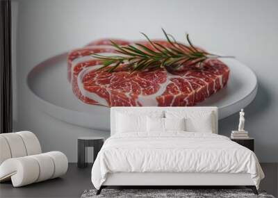 Closeup of a juicy and tender beef steak seasoned with fresh rosemary presented on a white plate against a plain background  This savory and premium meat dish is perfect for gourmet cooking Wall mural