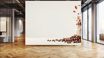 still life shot of roasted coffee beans exploding out of a burlap bag or sack scattered across a plain white studio background  The image captures the rich Wall mural