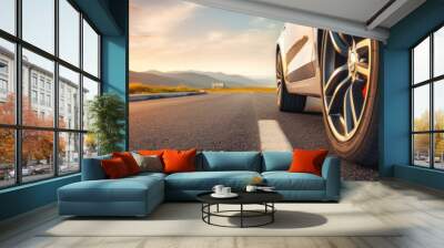 Close up tire and wheel of a car on the road in background. The driving concept of travel and vacation. Wall mural