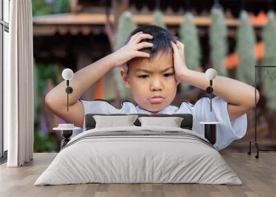 6-7​ years​ old​ child.​ Alone​ Asian​ little​ boy​ feel​ sad, headache and​ stressed.​ He​ lonely at​ the​ playground.​ Unhappy kid.​ Mood and​ emotions. Wall mural