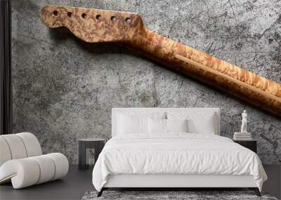 Bird eye maple guitar neck on old grey concrete with space. concept for wallpaper and writing text Wall mural