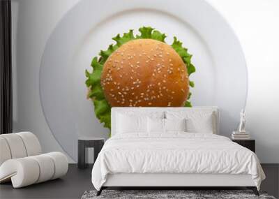 hamburger with lettuce in a plate on a white background, top view Wall mural