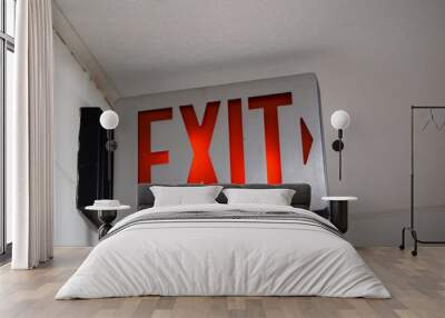 red emergency exit sign in the dark room. illuminated office exit sign. Wall mural