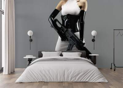 Futuristic portrait of a pretty young woman in a white dress, wearing a waist cincher, gloves, a black latex headband and an assault rifle in her hands Wall mural