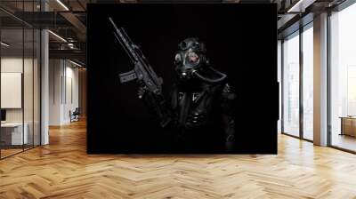 Futuristic warrior a machine gun in his hands Wall mural