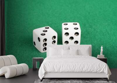 Pair of white dice on green felt with winning numbers seven and eleven showing Wall mural