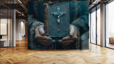 A close-up of hands clasped in prayer, with a crucifix and a vintage Bible in the background, symbolizing faith and hope Wall mural