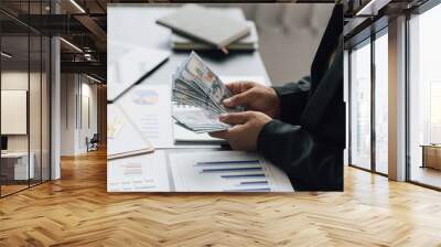 Businessman counting money for financial planning and accounting. Wall mural