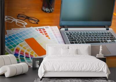 Graphic designer desk. Graphic designer laptop and color swatch examples. Wall mural