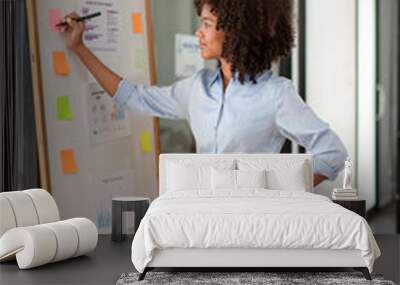 African American woman taking notes, writing in notebook, planning workday, meetings, writing down ideas or important information, Analyzing and taking notes Wall mural