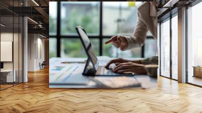 Businesswomen working together using laptop computer on office desk Wall mural