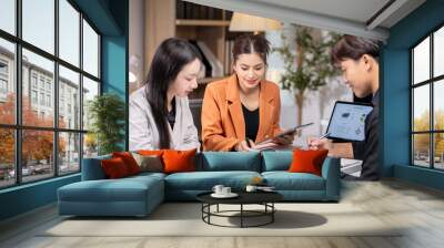 Group of asian business people analyzing business data on office desk Wall mural