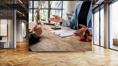 Lawyer explaining contract and offering agreement to client in office Wall mural