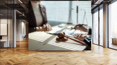 Lawyer explaining contract and pointing with pen while client is reading at office desk Wall mural