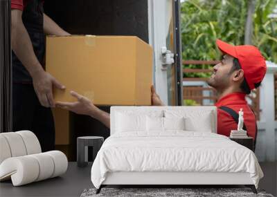 Portrait of two movers unloading boxes and furniture from a pickup truck.
 Wall mural