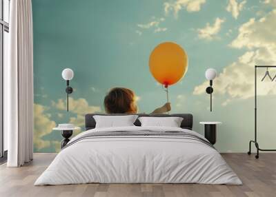 A child is holding a balloon on a string. Air balloon on the background of the sky. Rise to the sky. Light, weightless. Holiday concept. Happy Birthday- an inscription on a balloon. Great mood. Dream. Wall mural