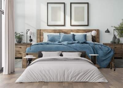 Rustic wooden bed with blue pillows and two bedside cabinets against white wall with three posters frames Wall mural