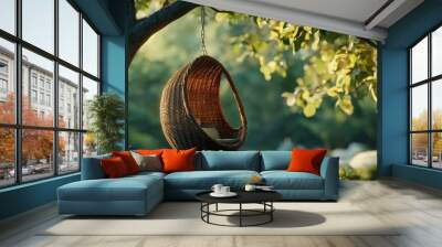 Woven rattan egg chair suspended from a tree branch Wall mural