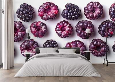 Sliced blackberries arranged in a circular pattern on a white background Wall mural