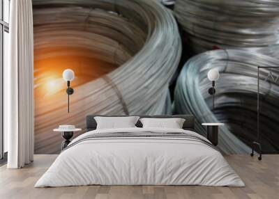 The blurry light design background of galvanize wire roll stacked ,in factory ,prepare for produce,warm light tone. Wall mural