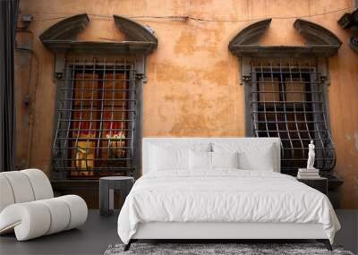 Bright colorful facade of old Italian building with windows, balconies and shutters. Pisa, Italy. Wall mural