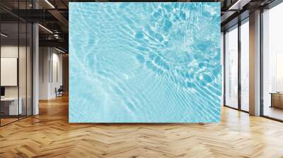 Blue water with ripples on the surface. Defocus blurred transparent blue colored clear calm water surface texture with splashes and bubbles. Water waves with shining pattern texture background. Wall mural