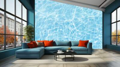 Blue water with ripples on the surface. Defocus blurred transparent blue colored clear calm water surface texture with splashes and bubbles. Water waves with shining pattern texture background. Wall mural