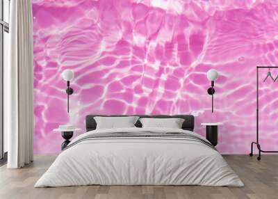 Pink water bubbles on the surface ripple. Defocus blurred transparent pink colored clear calm water surface texture with splash and bubbles. Water waves with shining pattern texture background Wall mural