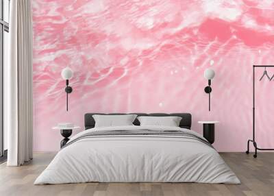 Pink water splashes on the surface ripple blur. Defocus blurred transparent pink colored clear calm water surface texture with splash and bubble. Water waves with shining pattern texture background Wall mural