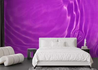 Purple water with ripples on the surface. Defocus blurred transparent blue colored clear calm water surface texture with splashes and bubbles. Water waves with shining pattern texture background. Wall mural