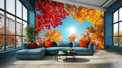 upward view of two tall trees with leaves in the vibrant colors of autumn Wall mural