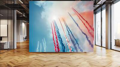 Vibrant red, white, and blue fireworks streaking across a clear blue sky, celebrating a patriotic event or holiday. Wall mural