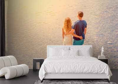 Happy young couple hugging on the beach Wall mural