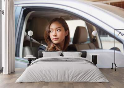 Close up portrait of a young business woman exiting a car Wall mural