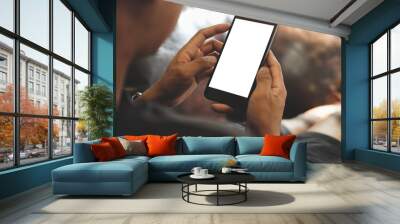 Cropped shot view of man hands holding smart phone with blank copy space screen for your text message or information content, female reading text message on cell telephone during in urban setting. 
 Wall mural