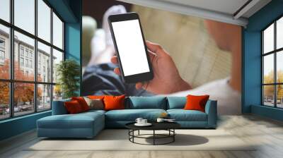 Cropped shot view of man hands holding smart phone with blank copy space screen for your text message or information content, female reading text message on cell telephone during in urban setting. Wall mural