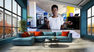 African american businesswoman having video call at office Wall mural