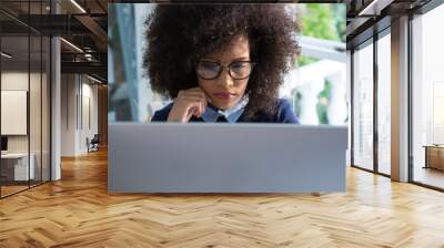 Beautiful woman working on desktop pc Wall mural