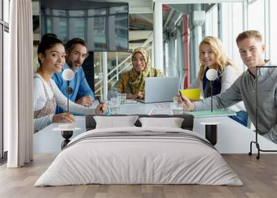 Business people looking at the camera during a business meeting in a modern office  Wall mural