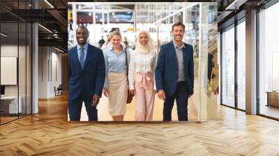 Business people walking together in the corridor at office Wall mural