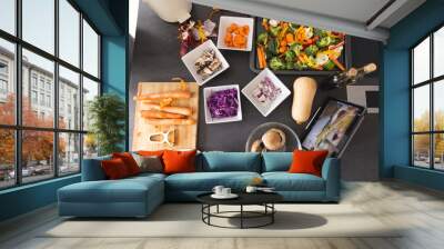 Fresh vegetables in bowls and tablet with cooking video on screen on kitchen counter at home Wall mural