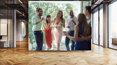 Group of friends having cocktail drink while interacting each Wall mural