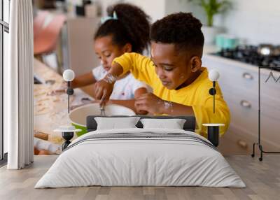 Happy african american siblings baking in kitchen Wall mural