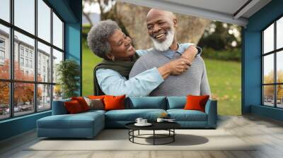 Image of happy african american senior couple posing at camera outdoors in autumn Wall mural