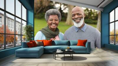 Image of happy african american senior couple posing at camera outdoors in autumn Wall mural