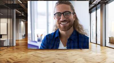 Male architect smiling in office Wall mural