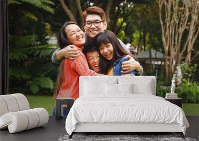 Portrait of happy asian parents, son and daughter smiling outdoors in garden Wall mural